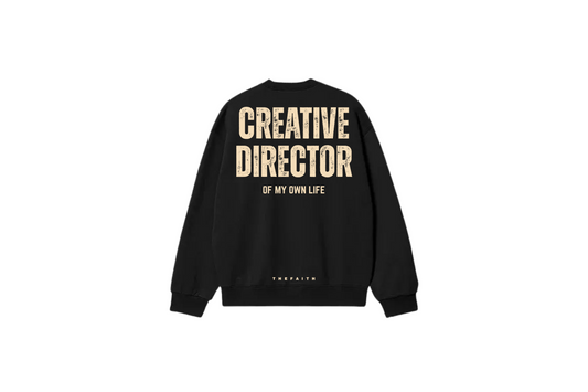 Black sweatshirt with 'CREATIVE DIRECTOR OF MY OWN LIFE' text on the back, brand name visible.